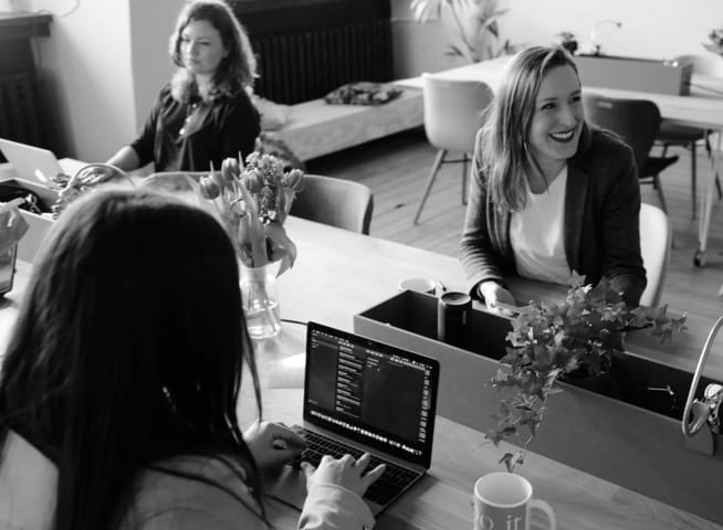 A photo of three employees in an office